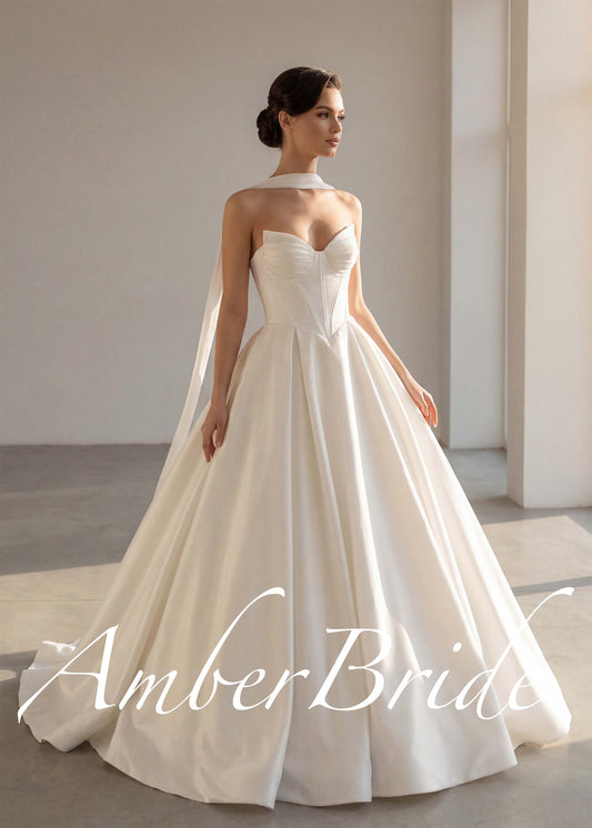 A-line satin wedding gown with a corset-style sweetheart bodice and draped neck scarf.