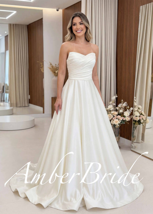 Ivory satin A-line wedding dress featuring a strapless sweetheart neckline and a pleated corset bodice.
