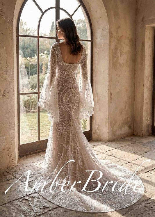 Back view of a boho mermaid wedding dress with square back, bell sleeves, and intricate white botanical lace.