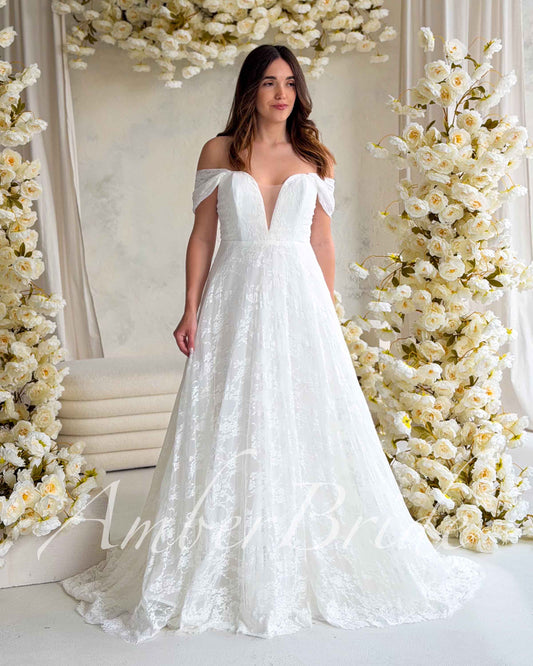 Romantic A-Line Lace Wedding Dress with Off-Shoulder Sleeves and Deep V-Neckline – front view | AmberBride