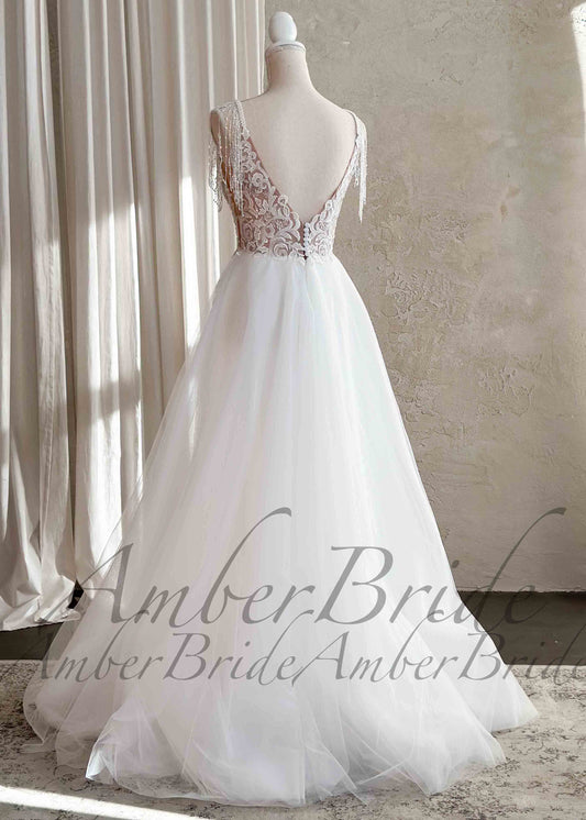 Boho A-Line Wedding Dress with Floral Appliques and Tassel Straps – front view, on dress form | AmberBride