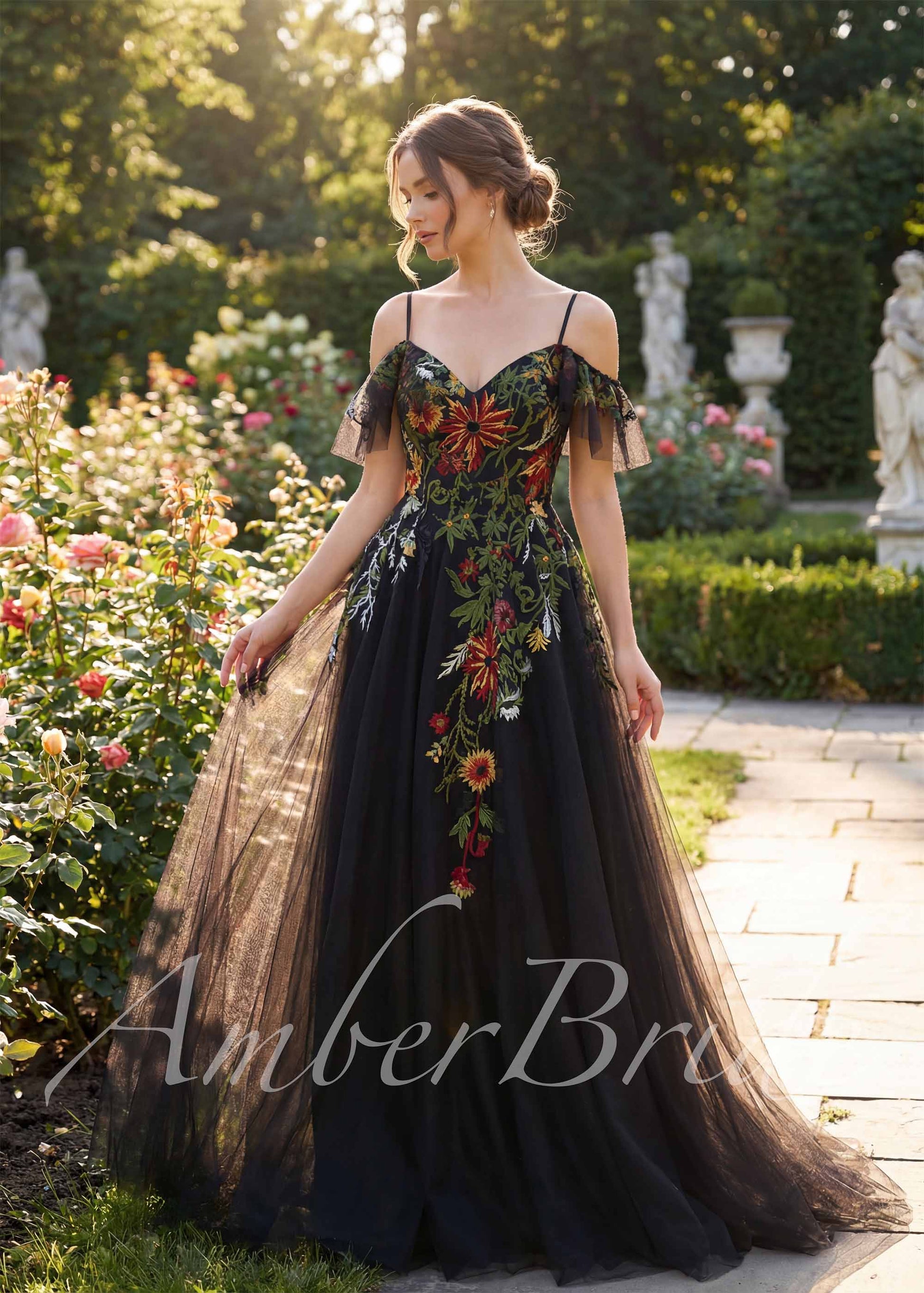 Black A-line tulle wedding dress with colorful floral embroidery, sweetheart neckline, and off-shoulder sleeves.