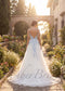 Back view of a white A-line tulle wedding dress with light blue floral embroidery, spaghetti straps, and open back.
