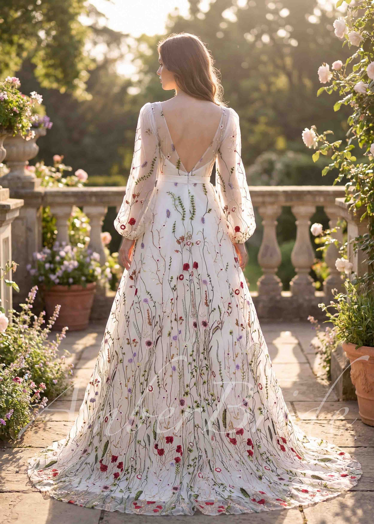 Back view of an A-line wedding dress with a deep V-back, long puffy sleeves, and colorful floral embroidery.