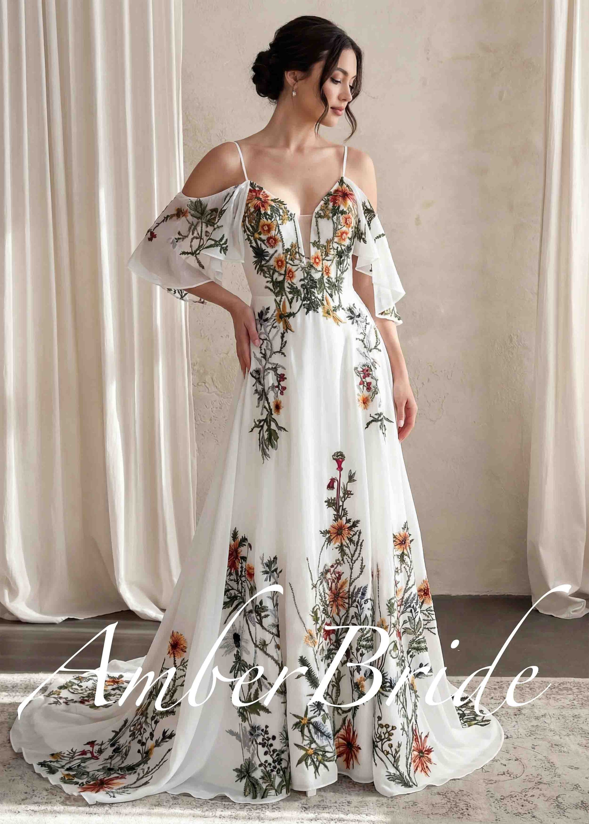 A-line wedding dress with floral embroidery, V-neck, and detachable flutter sleeves in white chiffon.