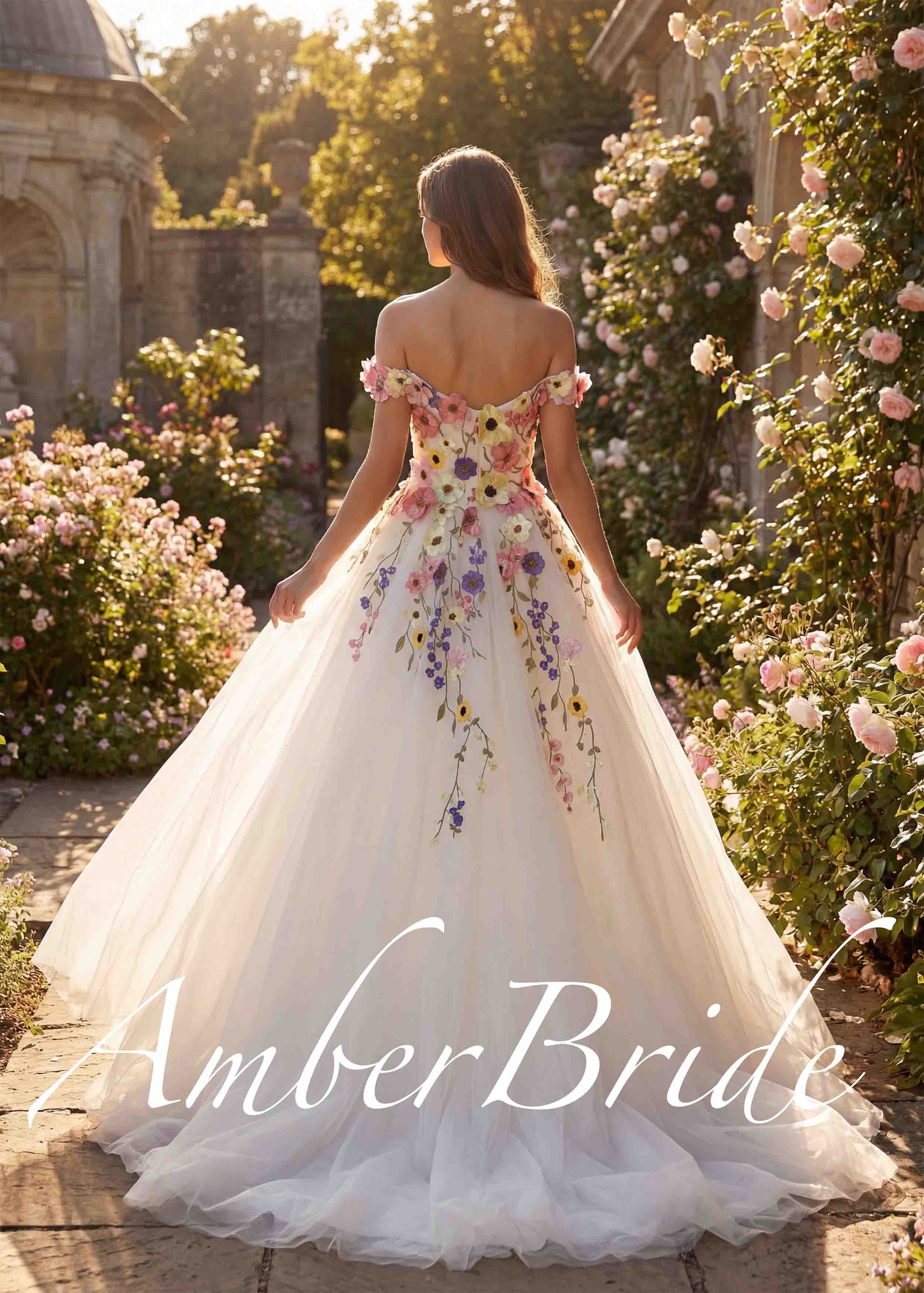 A-line off-shoulder wedding dress with colorful floral embroidery on white tulle in a garden setting.