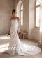 Strapless white satin mermaid wedding dress with lace long sleeves, a draped skirt, and a side lace slit.