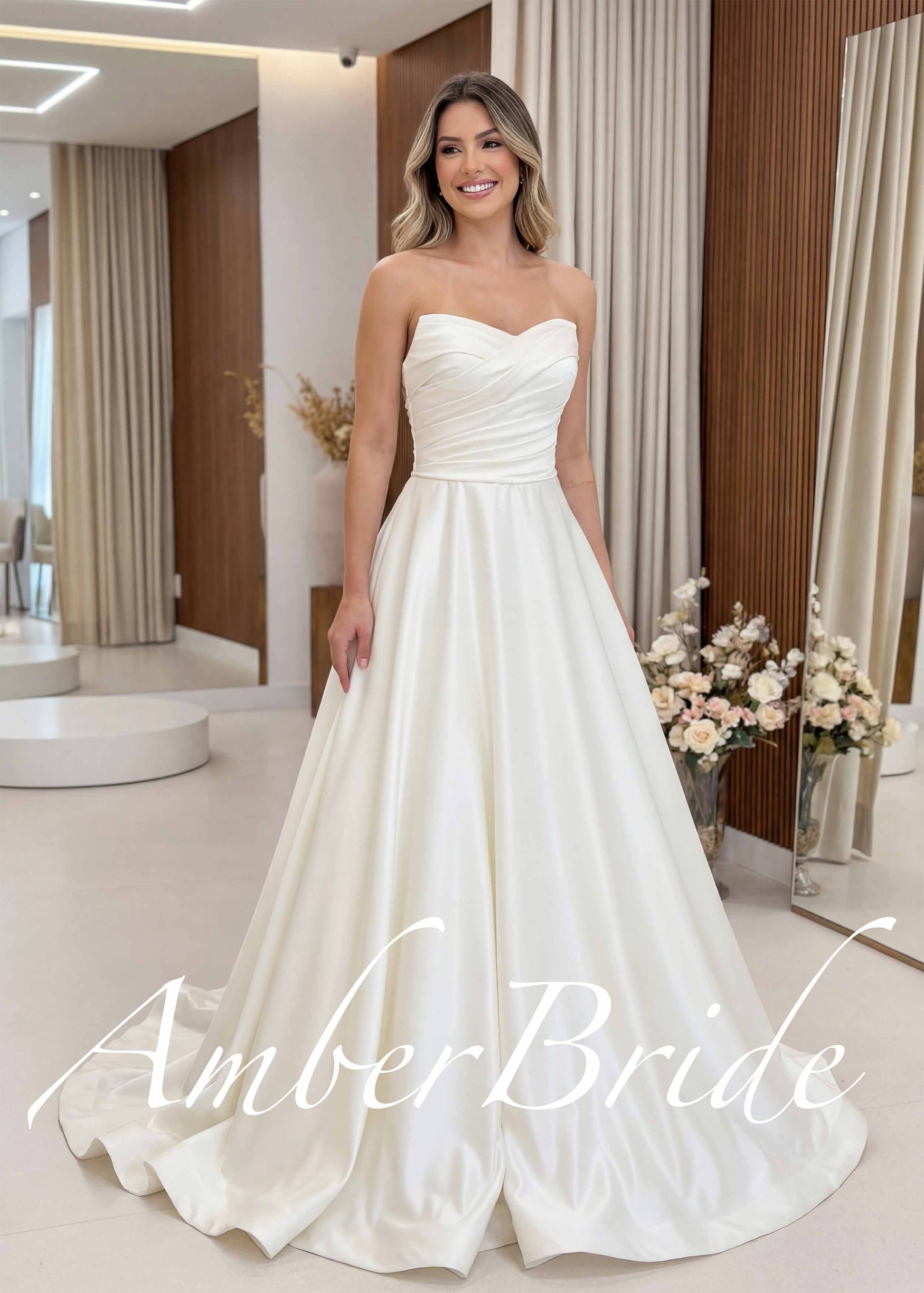 Ivory satin A-line wedding dress featuring a strapless sweetheart neckline and a pleated corset bodice.