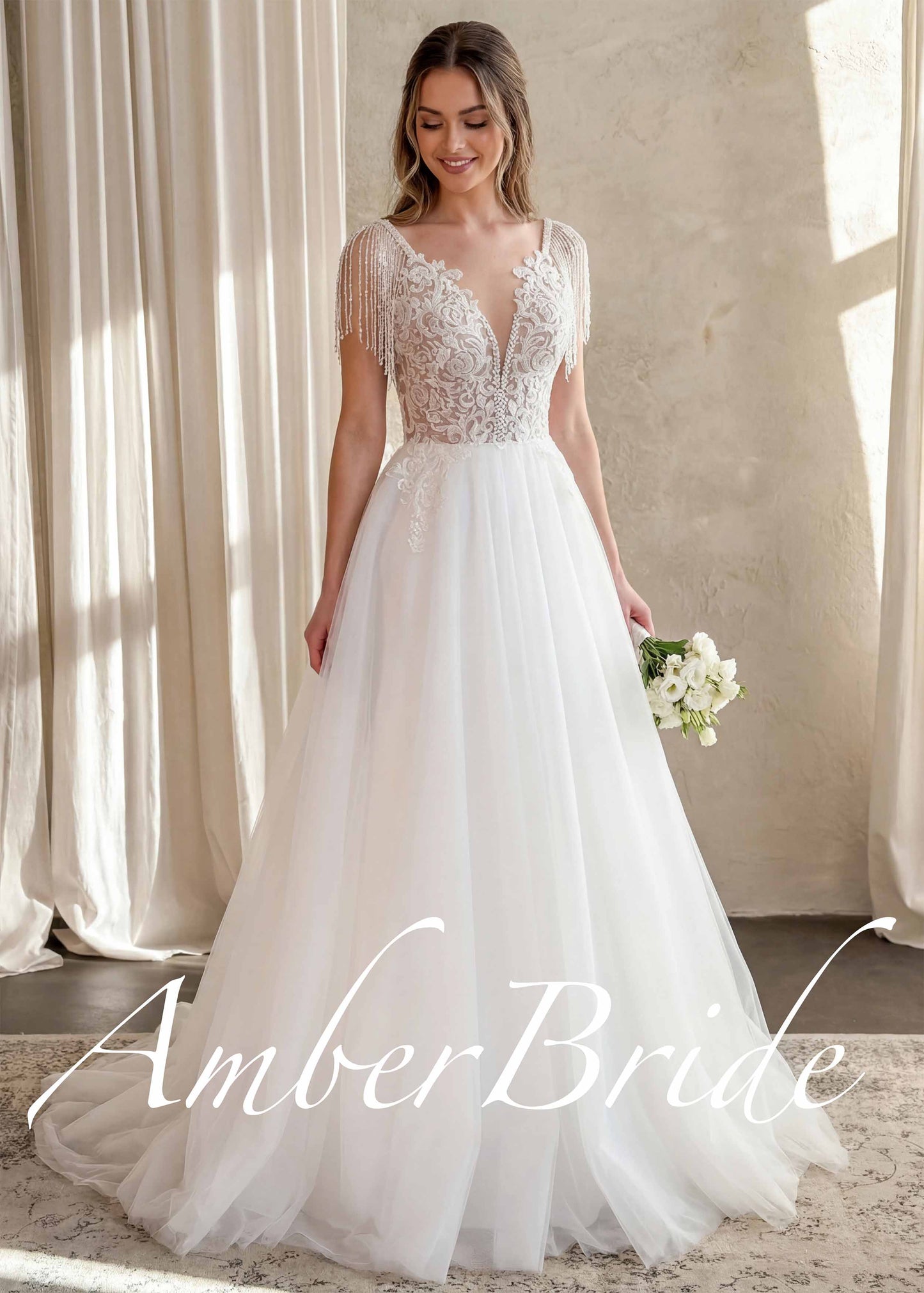 Boho A-line wedding dress with deep V-neck, floral lace bodice, and beaded fringe cap sleeves, and a tulle skirt.