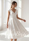 White satin tea-length A-line dress with V-neck, cap sleeves, and a defined waistband.