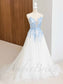 Sky blue floral applique wedding dress with a V-neck, spaghetti straps, and a floor-length tulle skirt on a mannequin.