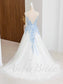 Back view of a white tulle A-line wedding dress with spaghetti straps, open back, and blue floral lace applique.