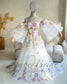 A-line wedding dress with sweetheart neckline, colorful floral embroidery, and sheer detachable puffy sleeves.
