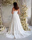 Back view of a white strapless A-line chiffon wedding dress featuring a ruched bodice and floor-length skirt.