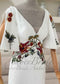 Ivory crepe mermaid dress with V-neck, detachable flutter sleeves, and earthy floral embroidery at bodice and sleeves.