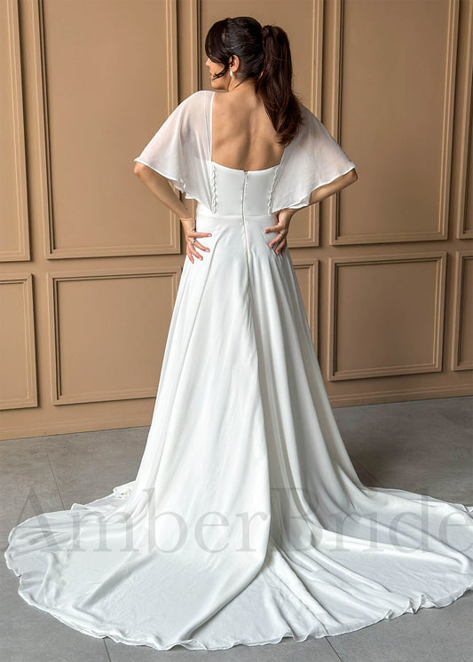 White A-line chiffon wedding dress featuring flutter sleeves, a square back, and button-down bodice detail.