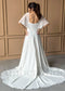 White A-line chiffon wedding dress featuring flutter sleeves, a square back, and button-down bodice detail.