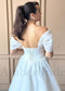 White organza A-line wedding dress featuring an off-shoulder neckline and a lace-up corset back.