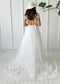 Back view of a white A-line wedding dress with a lace bodice, open back, short sleeves, and flowy tulle skirt.