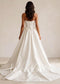 Strapless satin bridal ball gown with a full skirt and basque waistline
